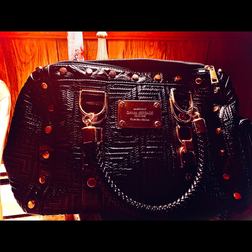 Gianni Versace black purse . Pre used . Like new